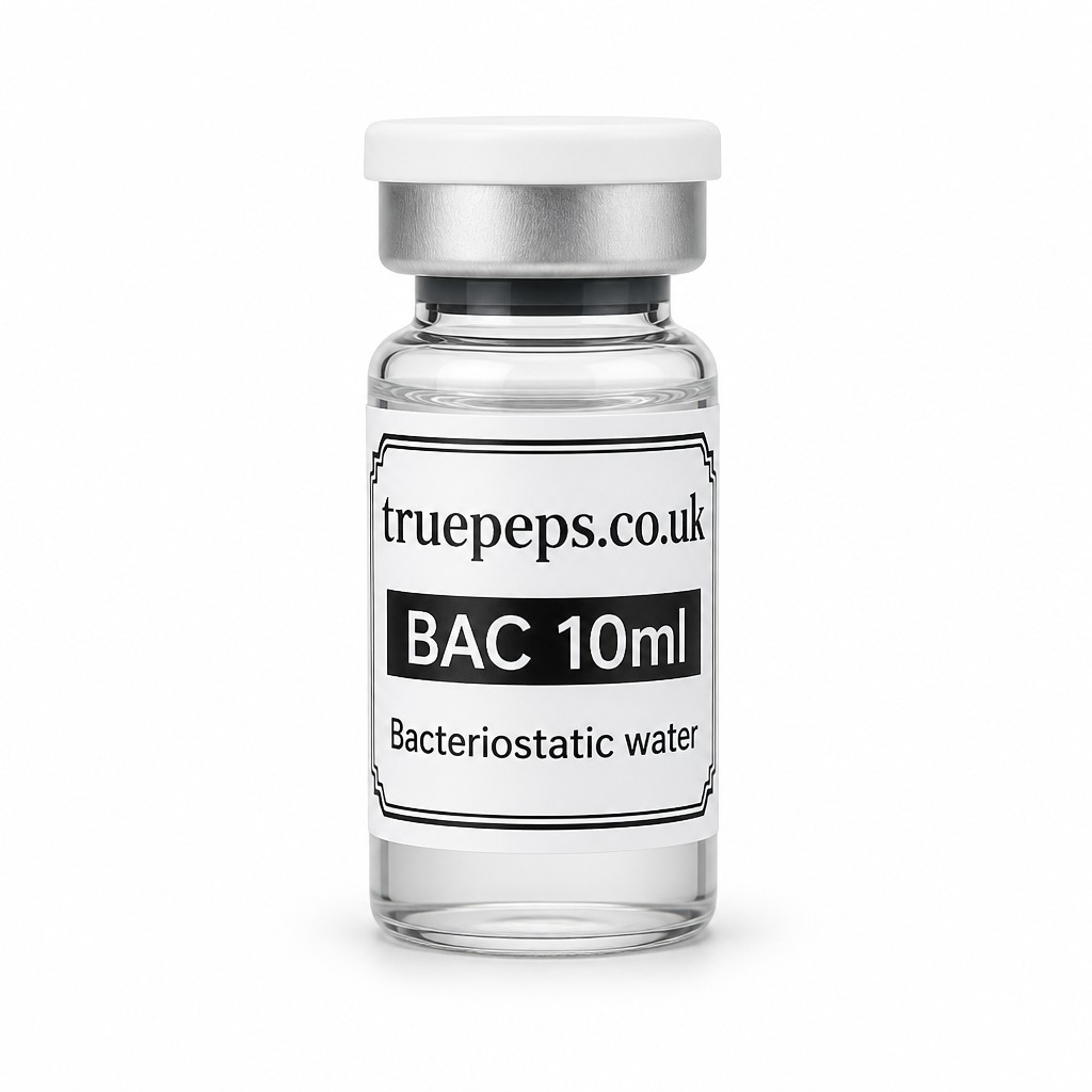Recreate the exact glass pharmaceutical vial shown in the reference image, with no design changes whatsoever — same white flip-off cap, same silver crimp collar, same clear glass vial filled with clear liquid, same white label with black double-line border (note: white label, not pink, unlike the peptide vials). Label text must match exactly: "truepeps.co.uk" at the top, a black bar containing "BAC 10ml" in white text, and "Bacteriostatic water" in plain text below. Do not alter colors, wording, logo, or label layout in any way.
Reframe only: center the vial upright in the middle of the frame, straight-on eye-level angle, full label facing camera and fully legible with no text cut off. Place on a seamless pure white studio background. Soft, even diffused studio lighting with no harsh glare on the glass or cap. Subtle soft realistic shadow directly beneath the vial. Sharp focus throughout, especially the label text. Professional e-commerce product photography style, high detail, 4K.